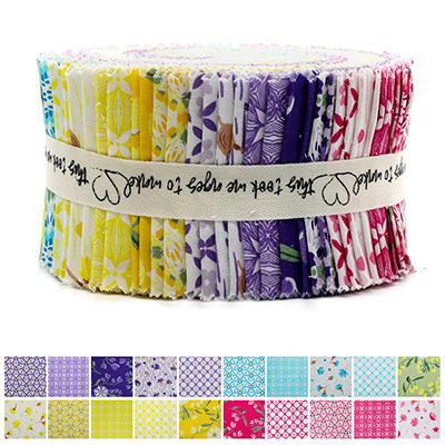 A roll of colorful fabric strips featuring various liberty patterns, tied together with a white ribbon printed with heart shapes and text. The roll includes vibrant shades of purple, yellow, blue, pink, and green, showcasing intricate floral and geometric designs.