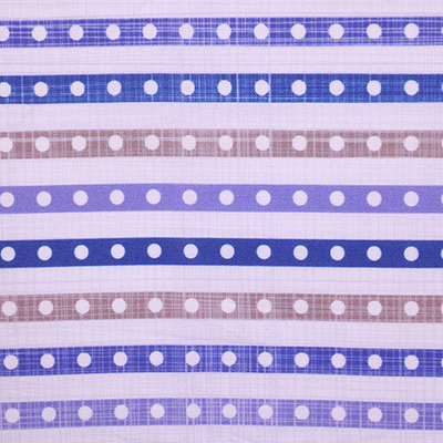 A close-up image of fabric with alternating blue, purple, and beige stripes decorated with white polka dots, with a ruler indicating scale.