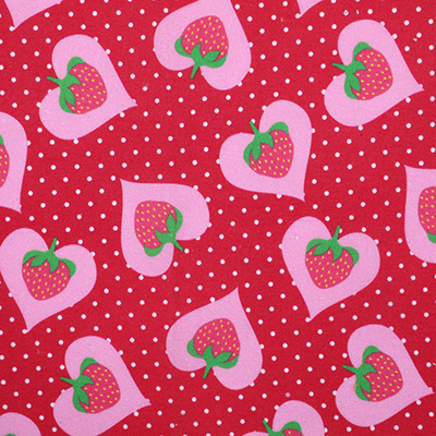 Red fabric with white polka dots and pink heart-shaped strawberries.