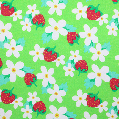 Bright green fabric with a pattern of white flowers and red strawberries, displayed flat.