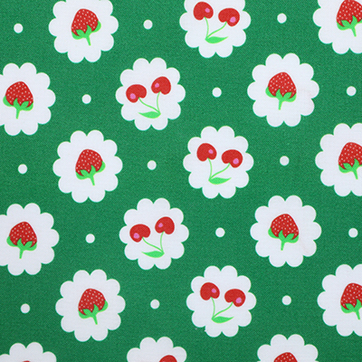 Green fabric with a pattern of strawberries and cherries on white cloud-like shapes.