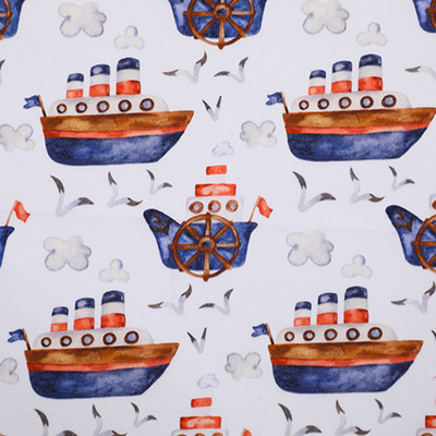 A white fabric with illustrations of ships, seagulls, and clouds. The ships are painted in blue and orange, featuring smokestacks and flags, creating a nautical theme. The fabric is laid out flat, showing the repeating pattern.