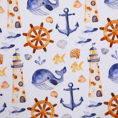 A white fabric with a nautical theme displaying a pattern of lighthouses, ships' wheels, anchors, whales, seashells, and fish in shades of blue and orange. The design is arranged in a repeating pattern, creating a cohesive maritime aesthetic.