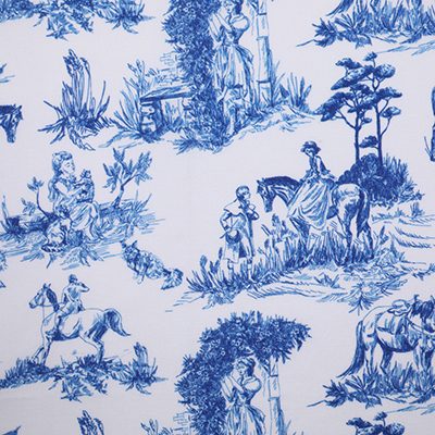 A close-up view of a blue and white fabric with pastoral scenes depicting people and animals in a rural setting.